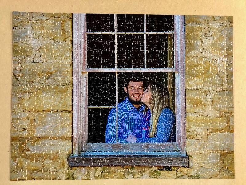 Custom 500 piece jigsaw puzzle with a couple kissing as the image. The personalized puzzle was given as an anniversary gift