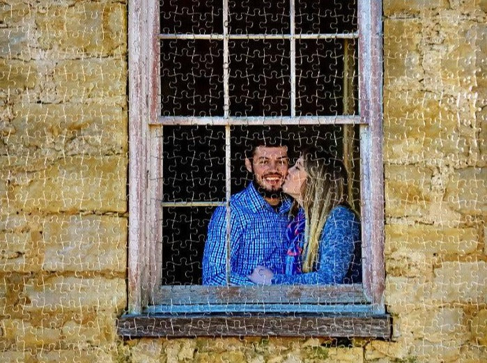 Custom 500 piece jigsaw puzzle with an image of a couple kissing in a window
